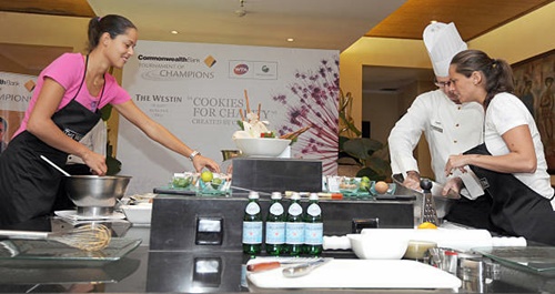 Ana Ivanovic (L) and Roberta Vinci(R) baking cookies